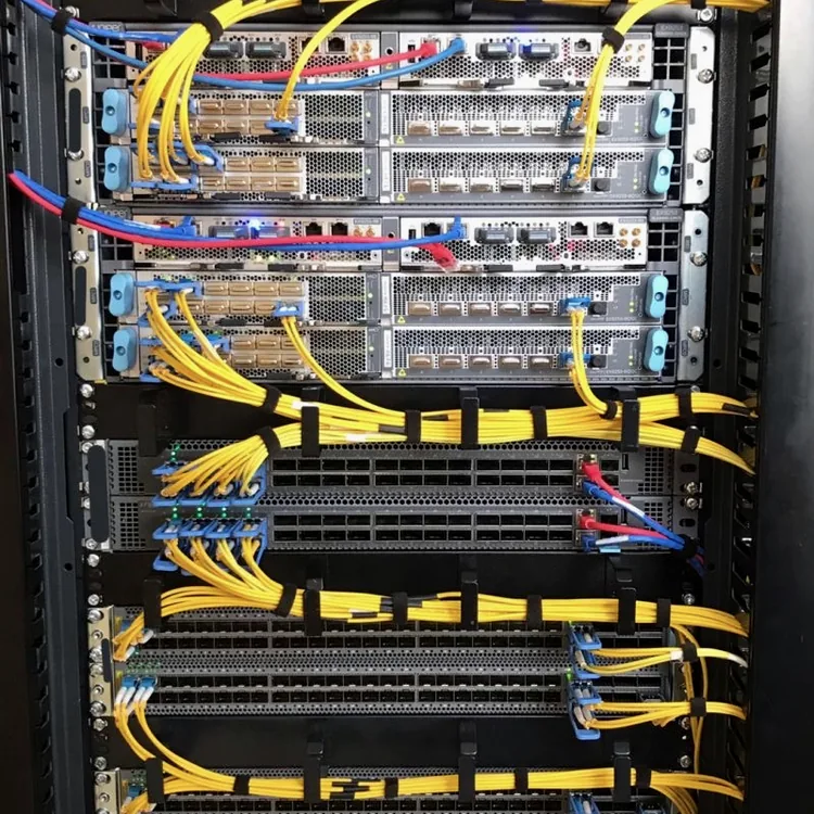 Fiber optic cabling running across a live network rack
